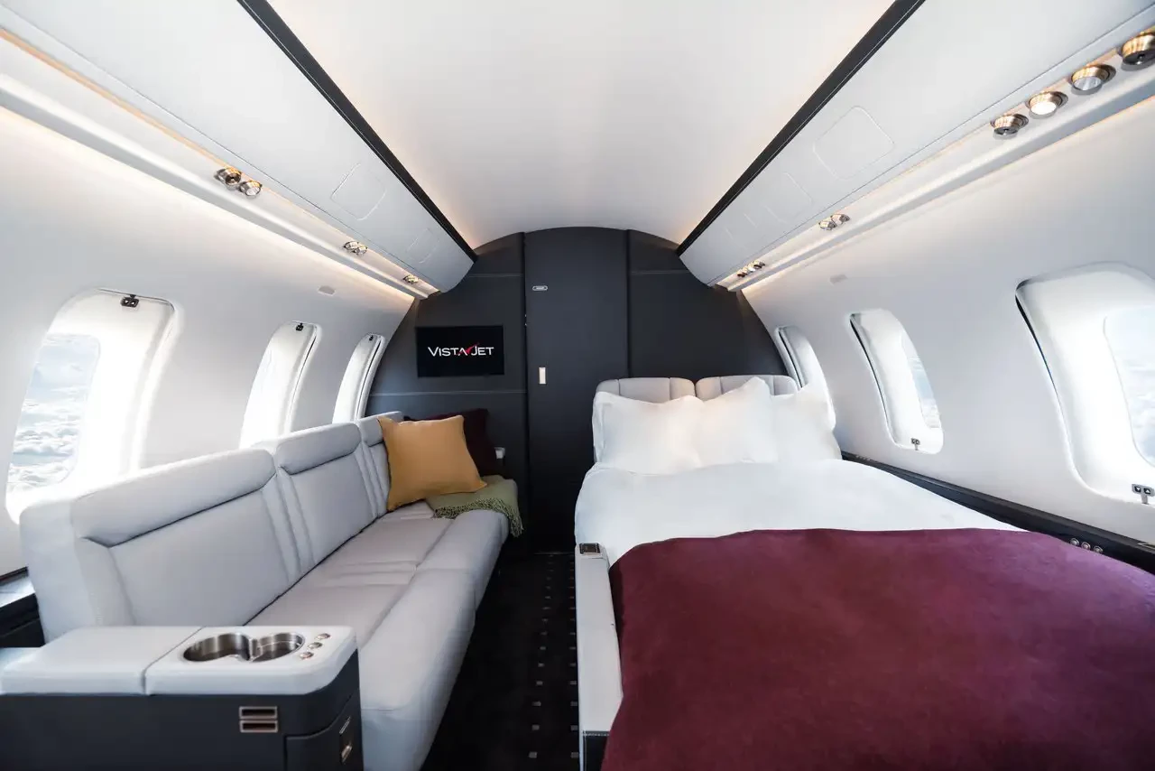 A VistaJet cabin that includes a bed