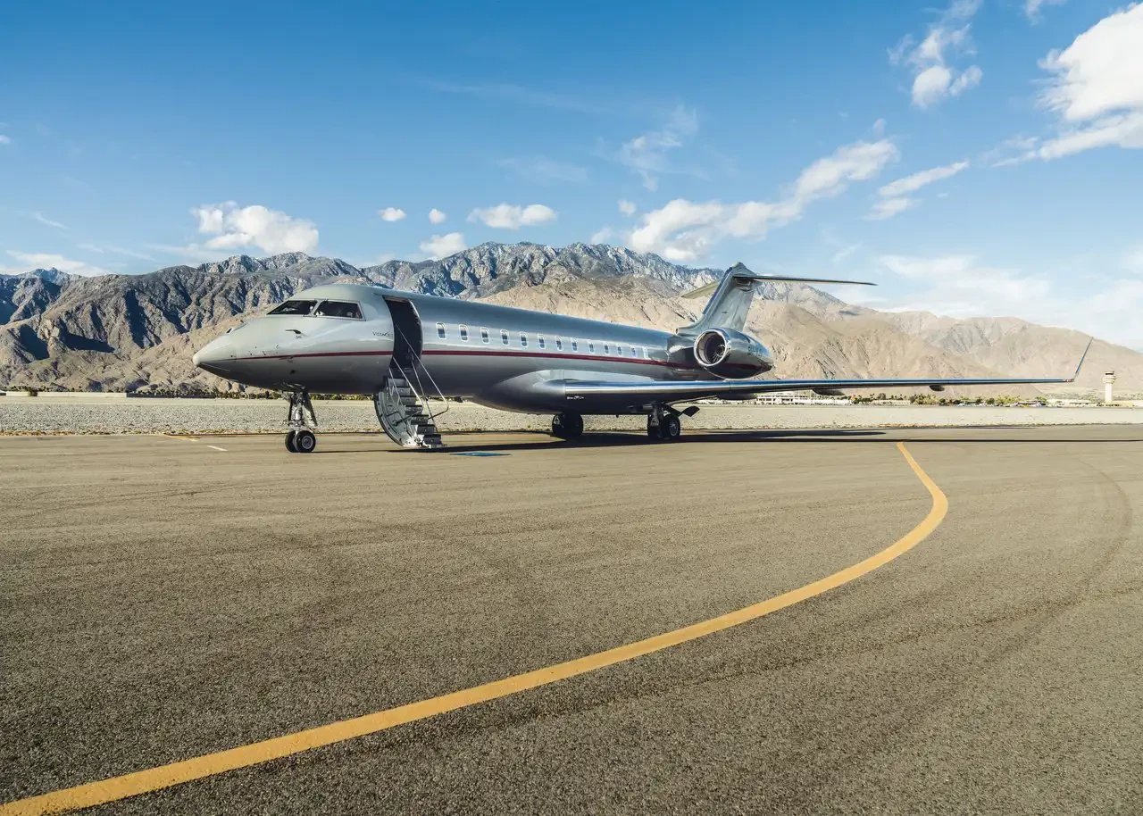 A vistaJet plane on the runway, the stairs are down with the door open
