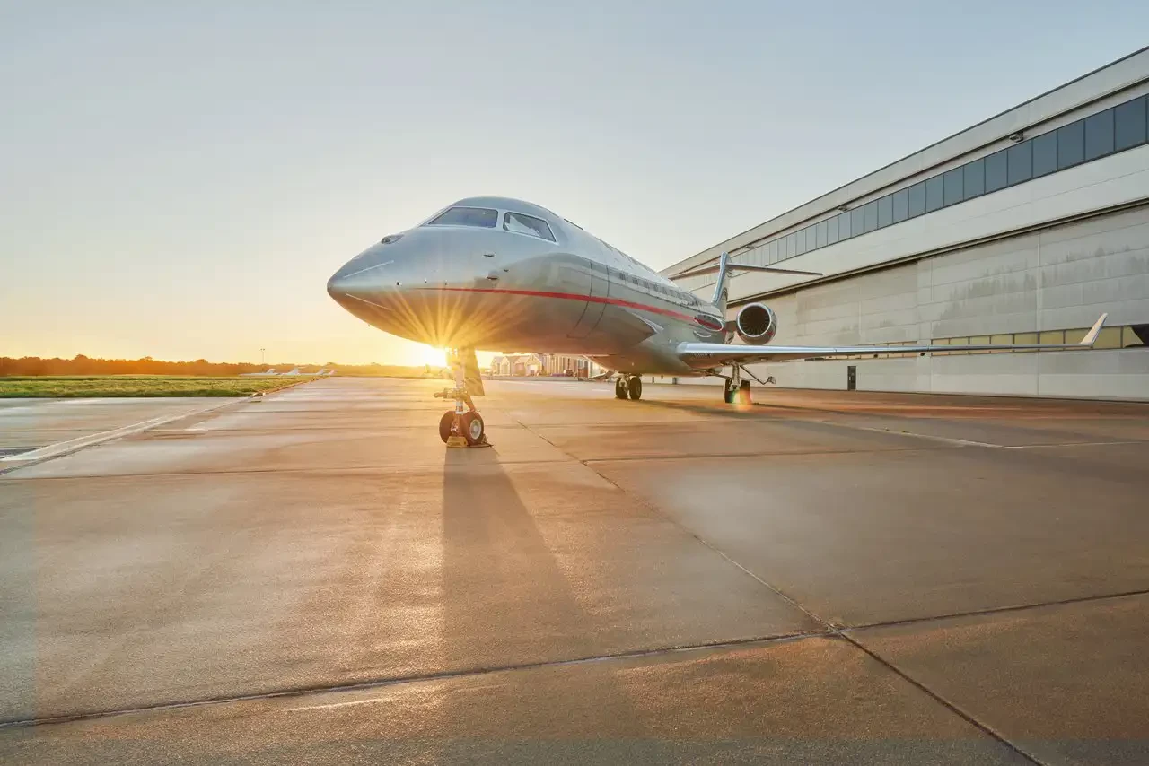 A VistaJet plane in front of a specialised hanger