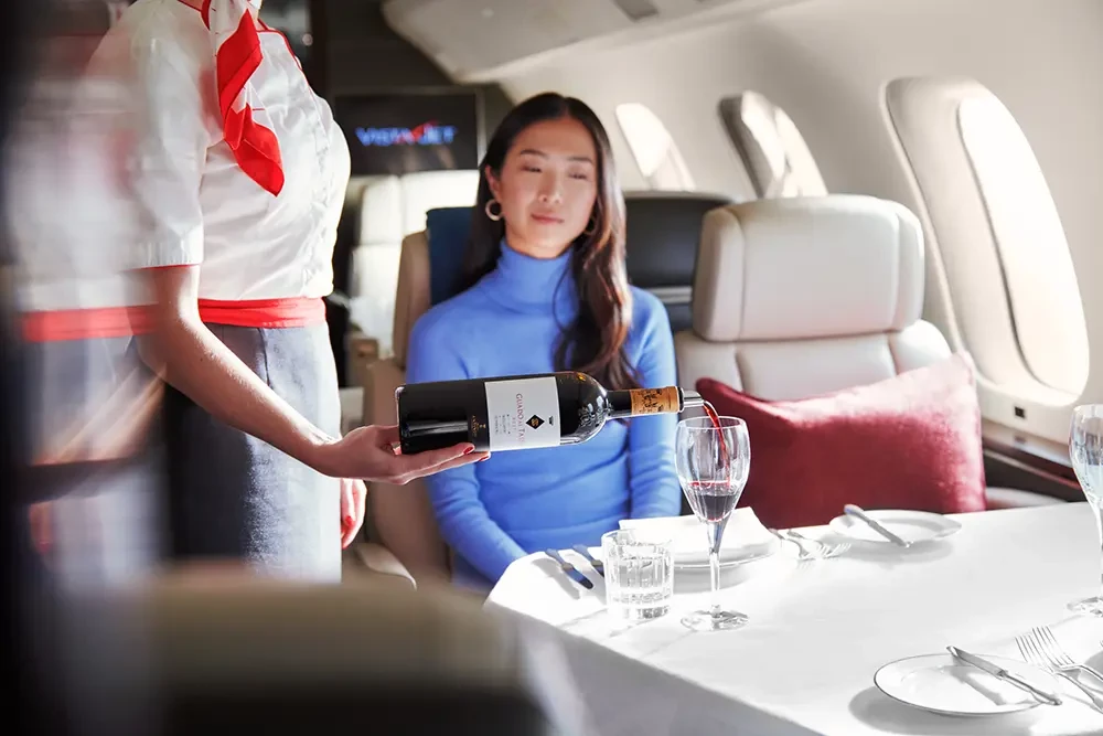 VistaJet Hostess Pouring Wine